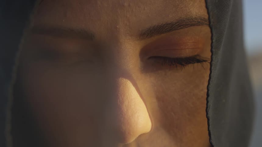 Close up of woman in black veil with eyes closed