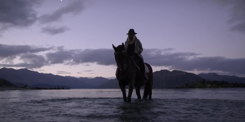 Woman Riding Horse In Lake