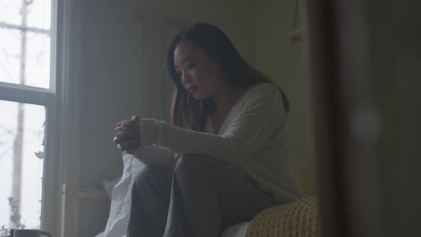 Woman sitting on a bed