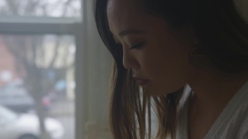 A woman concentrates on something below her
