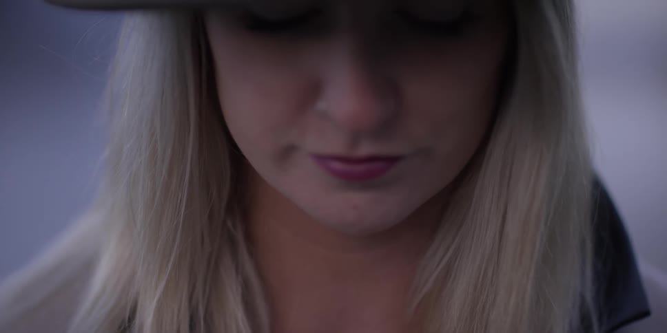 A woman is looking down at something