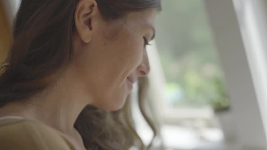 Woman smiles as she works