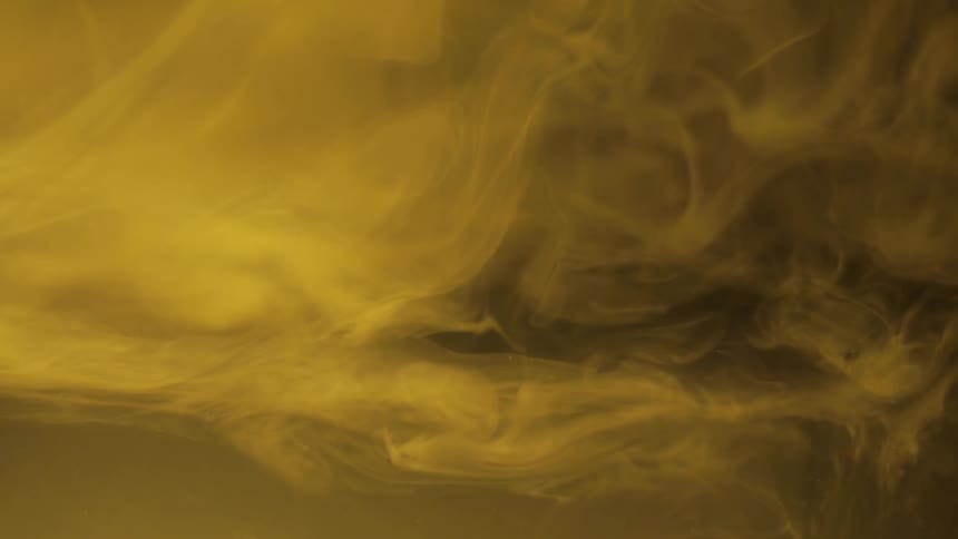 Smoke billowing before a brownish yellowish background