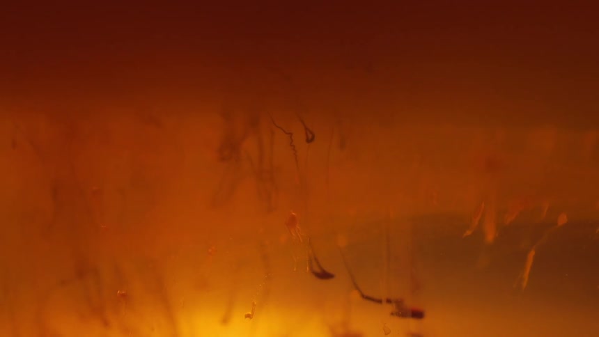 Small debris falls into an orange body of water