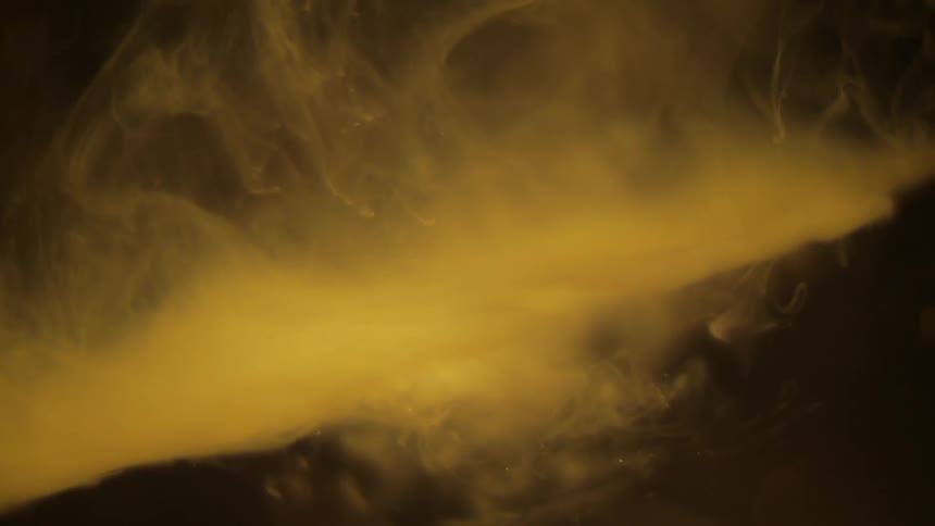 Haze floats against a yellow and black background