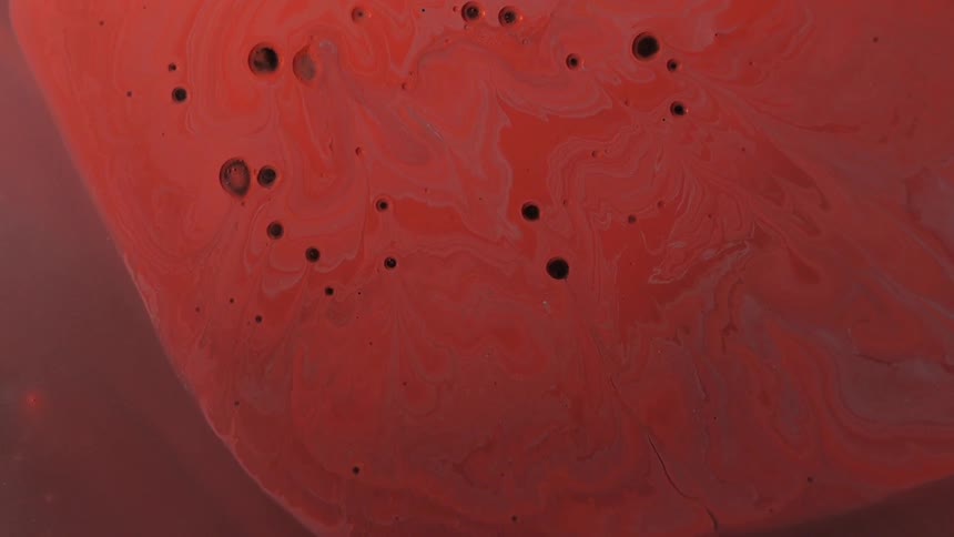 Orange water with black blobs