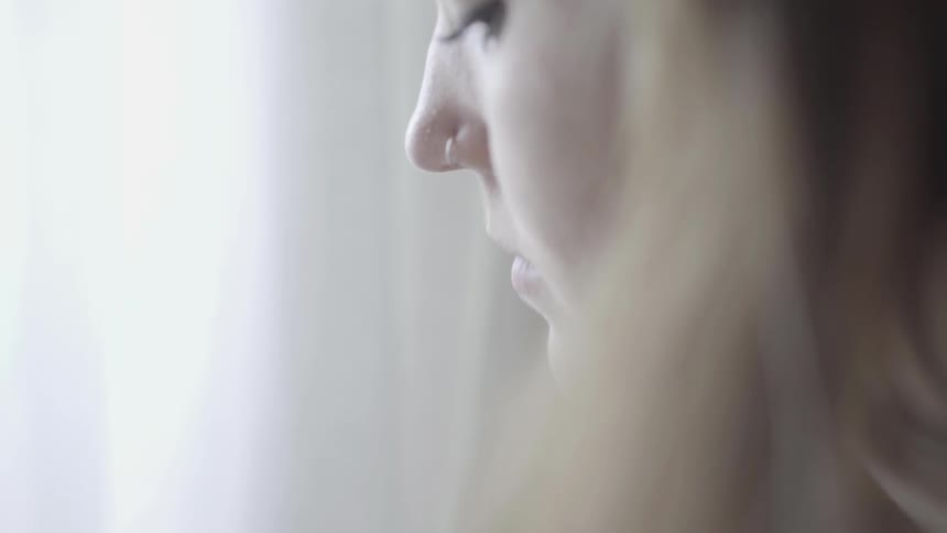 Close up of woman with pierced nose standing on a room