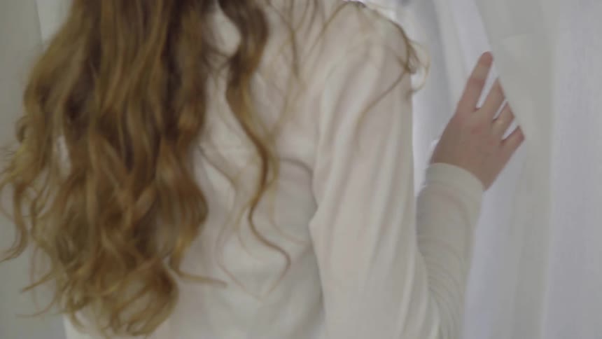 Girl walking through a curtain