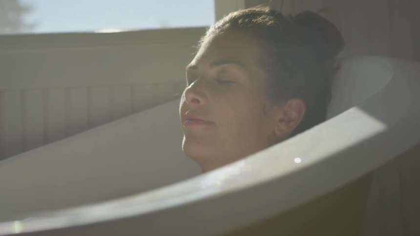 Woman relaxing on a bathtub