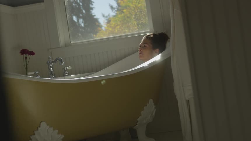 A woman soaking in a bathtub