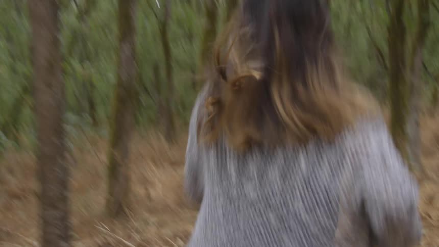 Woman running through the woods