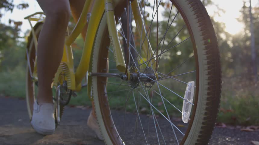 Woman sitting on bicycle on trail