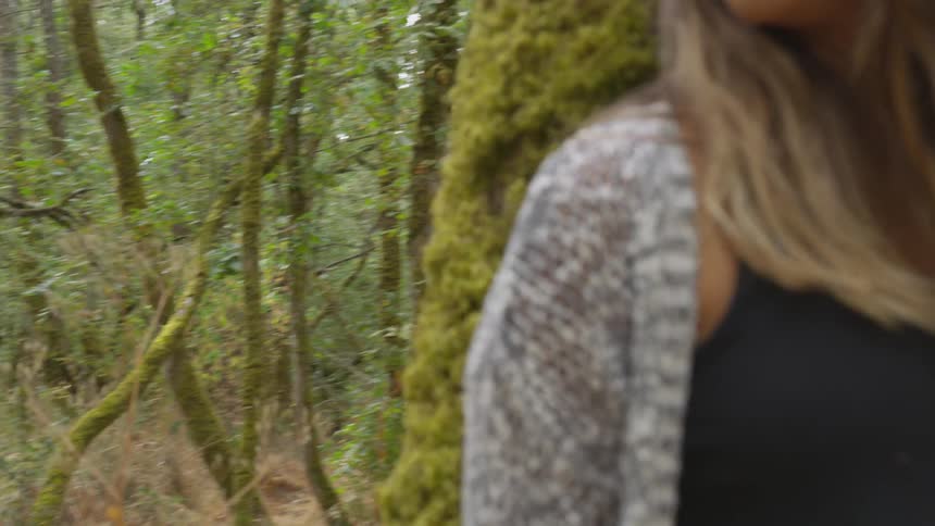 A woman leaning on a tree
