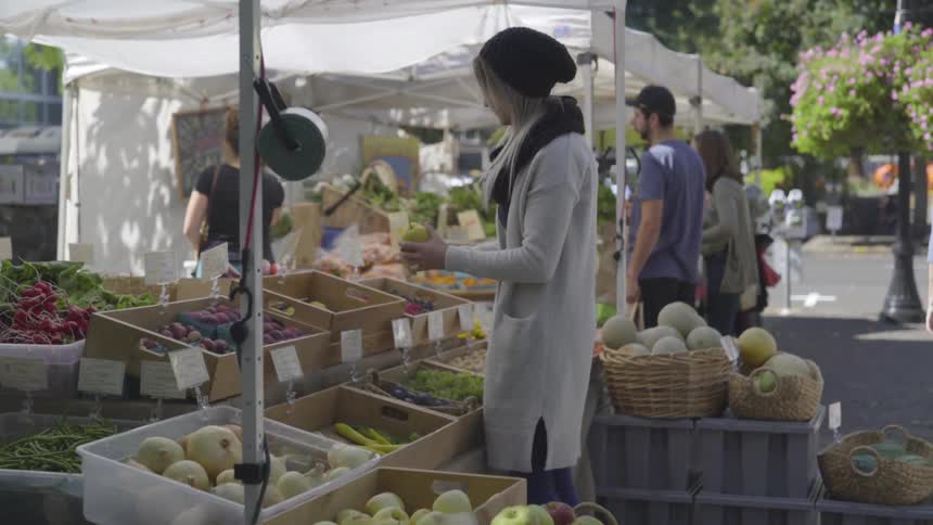 People are shopping at the local farmers market