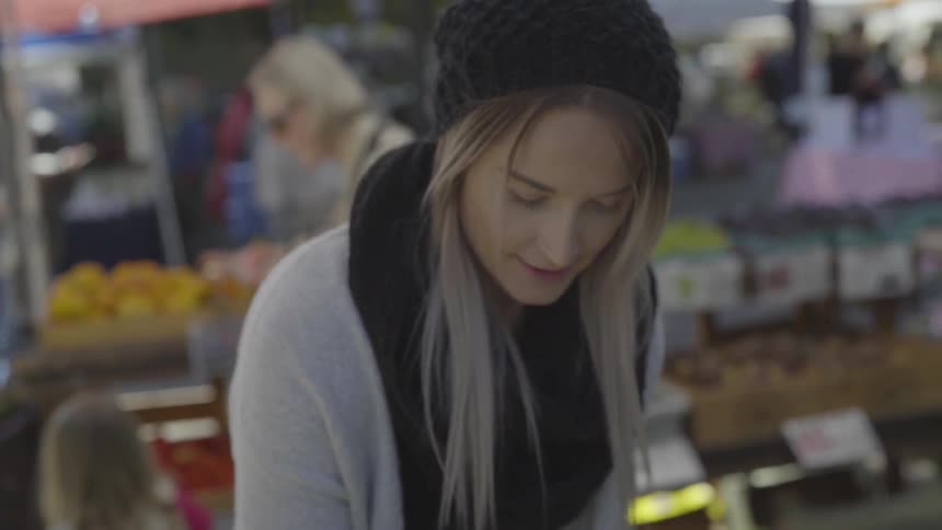 A woman shops are an outdoor market
