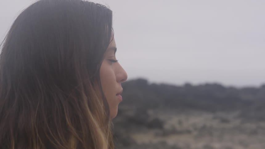 A woman outside staring into the distance