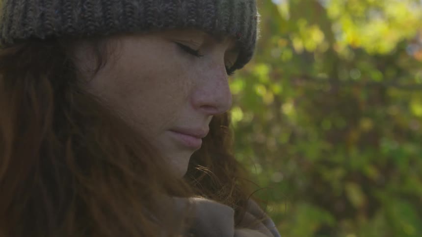 A person experiences nature with eyes closed