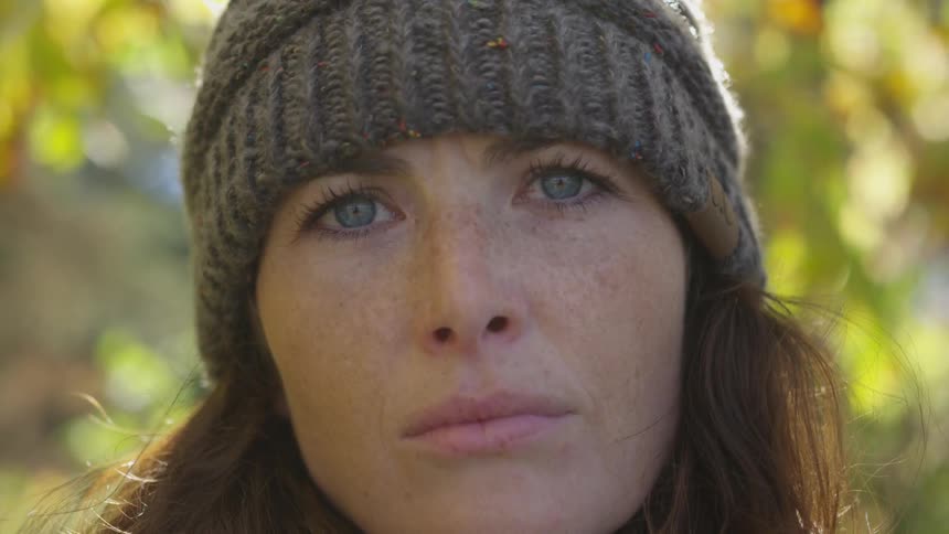 Head only of a woman wearing a hat and looking straight ahead