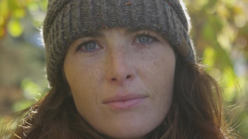 Woman in knit hat stares