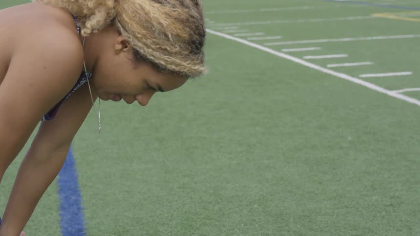 Woman stops and breathes in at a track