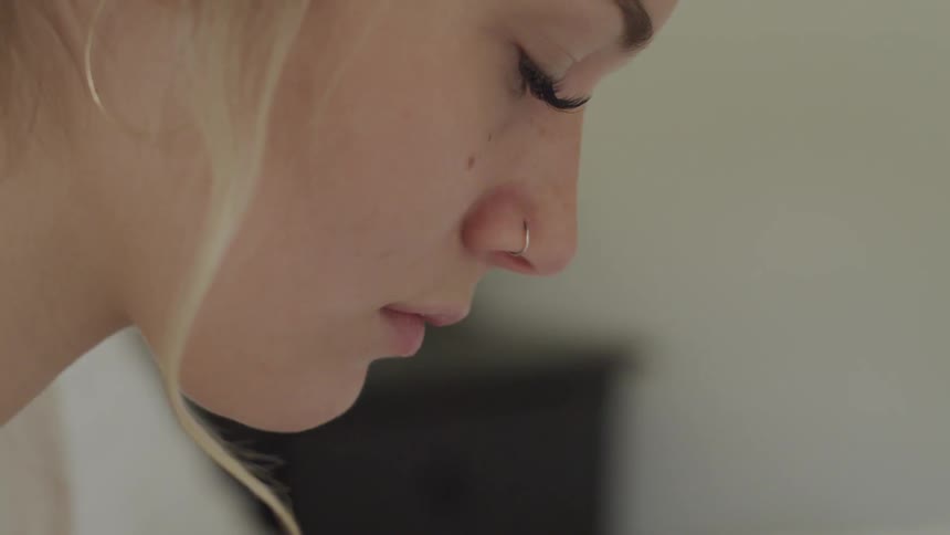 A woman looks down towards the floor
