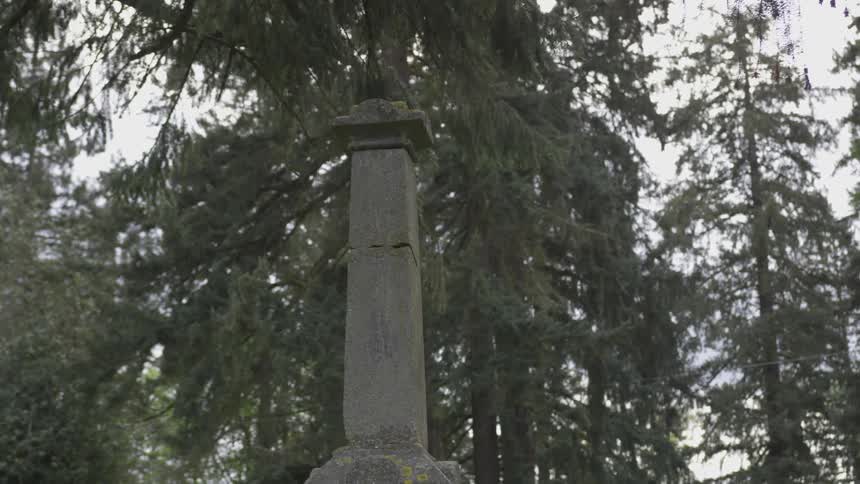 An old stone monument in a wooded area