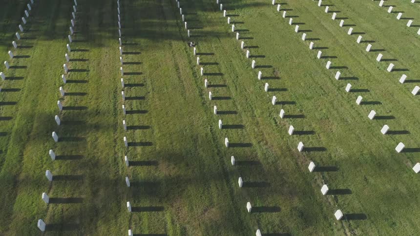 View of cemetery with full of white tombs in the daytime