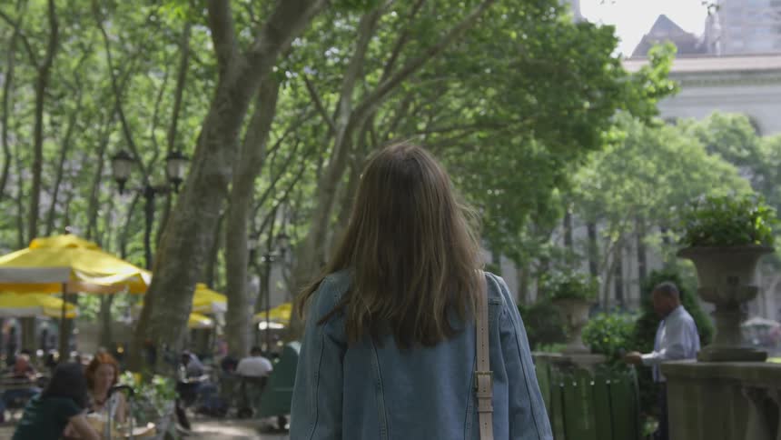 A woman walks through the park