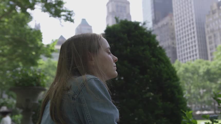 A woman sitting outside in a park