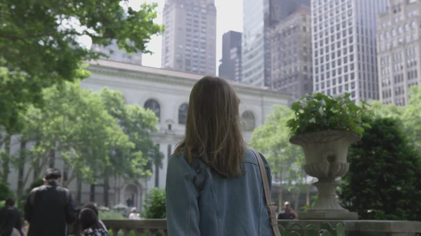 A woman walks through the park