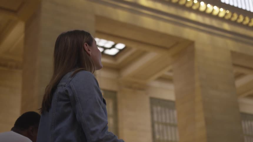 A woman standing in a train station