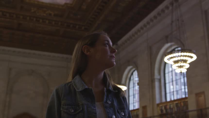 Young woman admiring the church she is standing in the center of