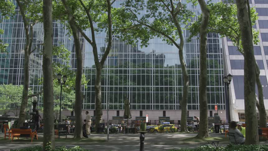 People spend time in public park in front of a big building in the daytime
