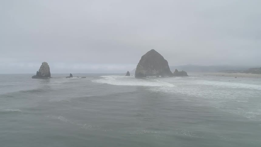 Landscape view of waves crashing in to a cliff