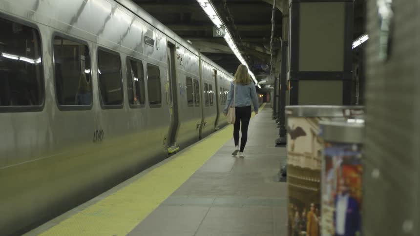 Woman walking along an empty subway alone