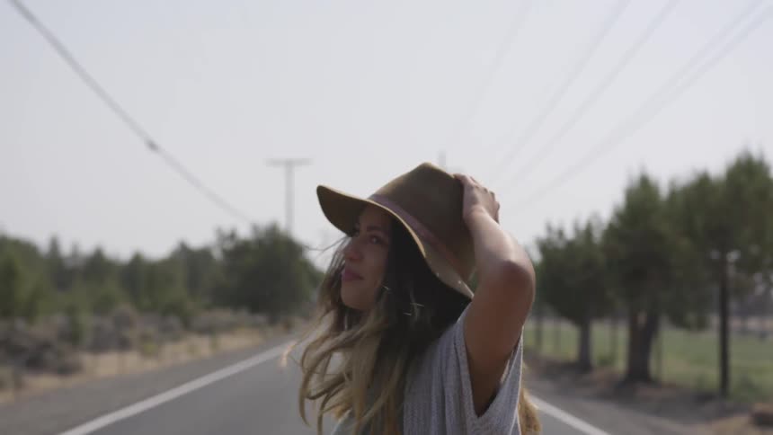 A woman is jumping as she moves down the road
