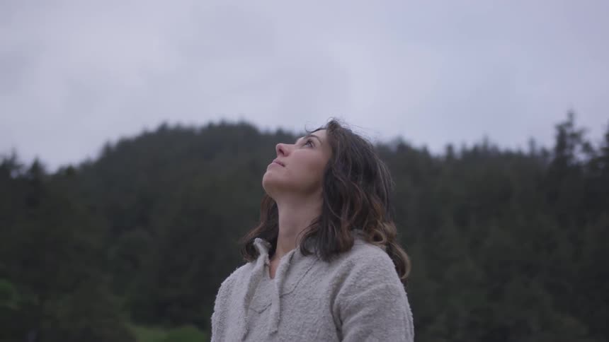 A woman stares into the sky