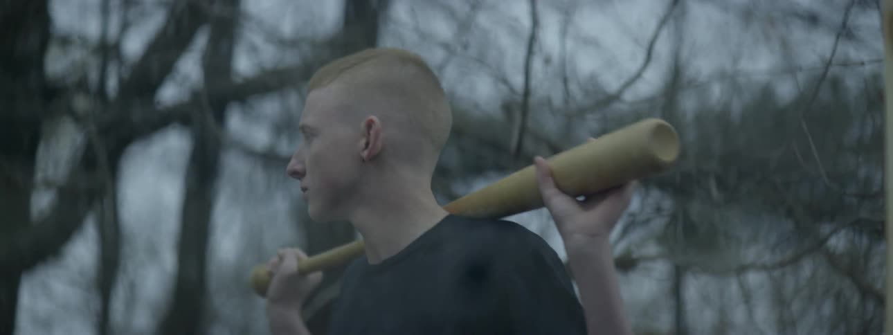 A boy holding a baseball bat outdoors