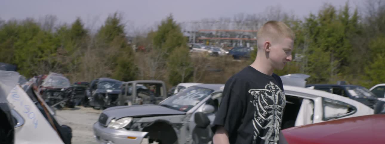 A person walking in a junkyard