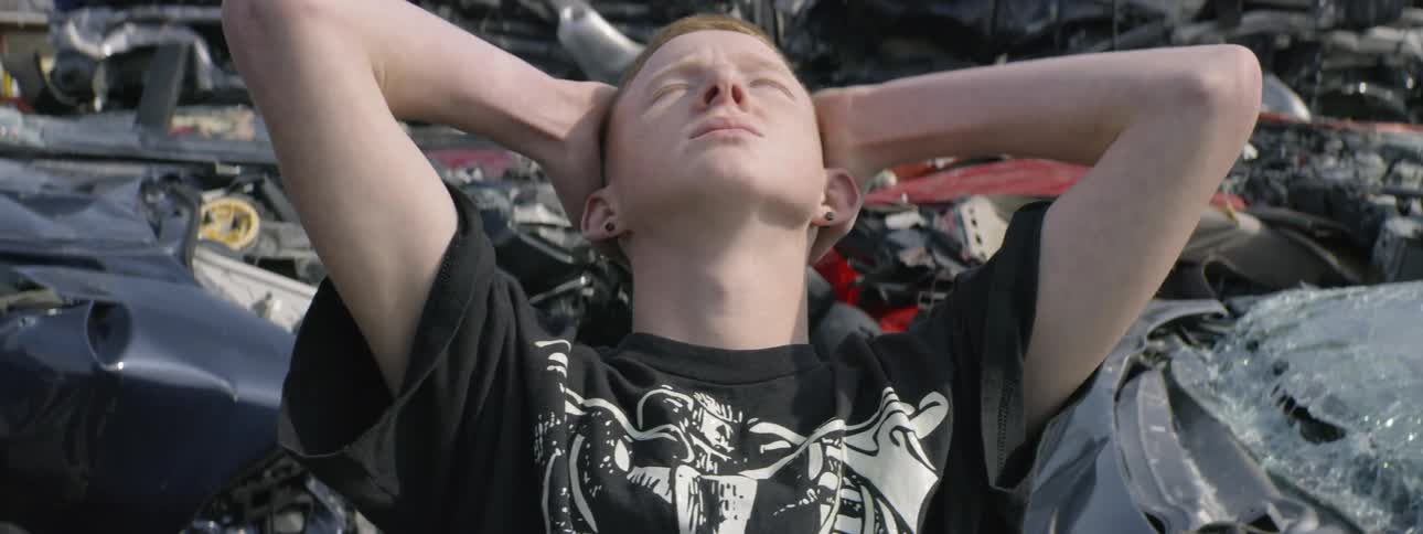 A young boy stands in the wreckage