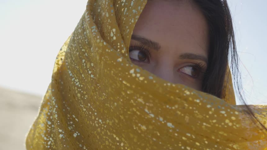 A young woman with a sari over her mouth