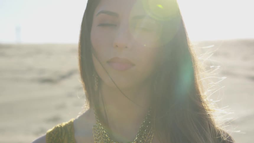 A beautiful brunette woman stares straight ahead