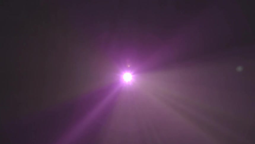A bright colored light shines down from above