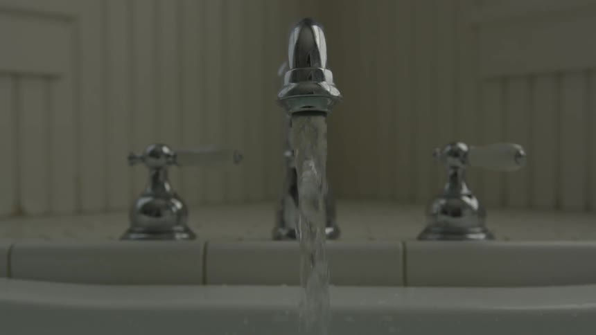 Water flows from the chrome faucet