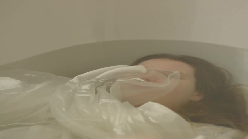 A woman with a mask submersed in water