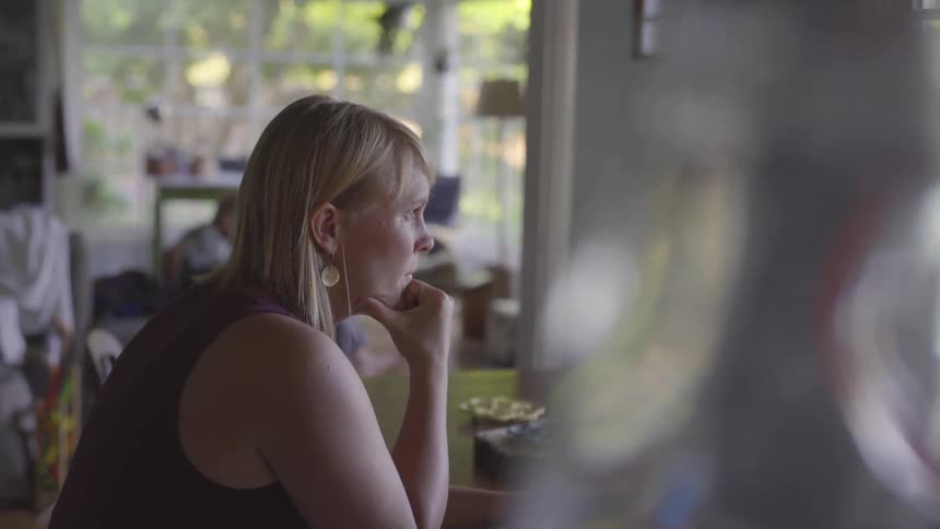 Girl sitting at the table on the computer