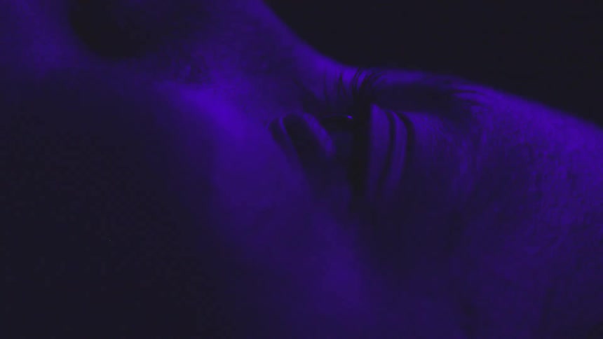Close up of woman opening her eye from side view