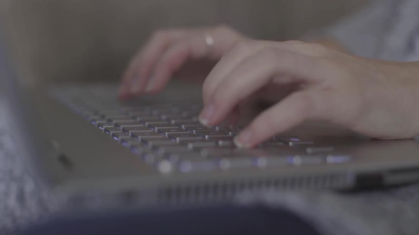 A person typing on a laptop