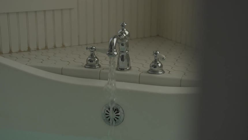 Faucet pouring water on bathtub