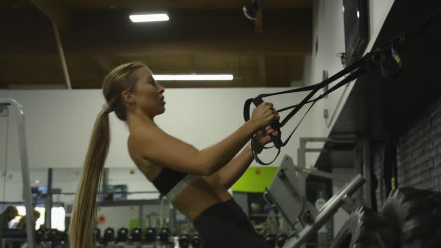 A young white woman exercises at the gym